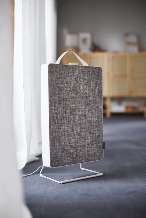 IKEA FÖRNUFTIG air purifier standing on a wire foot by a window