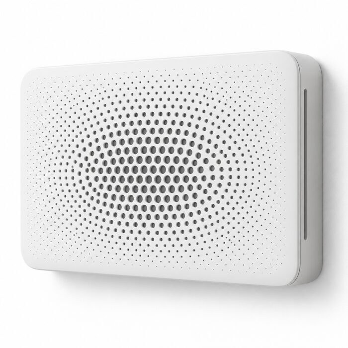 A white wall-mounted air filter with a perforated front, in soft studio light